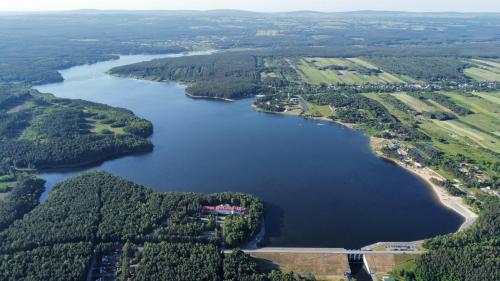 an aerial view of a large lake with trees at Domek - Carineczka Chańcza in Chańcza
