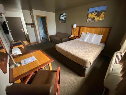 a small hotel room with a bed and a table at Rocker Inn in Butte