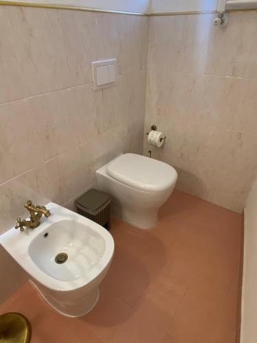 a bathroom with a white toilet and a sink at Filippo Secondo in Naples