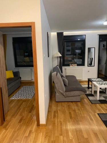 a living room with a couch and a table at Family Home Niš , FREE parking in Niš