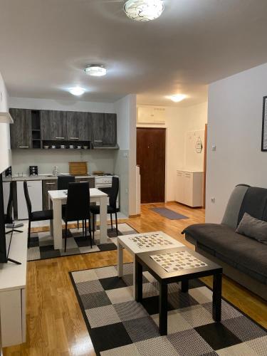 a living room with a couch and a table at Family Home Niš , FREE parking in Niš
