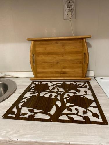 a rug on the floor next to a wooden box at Family Home Niš , FREE parking in Niš