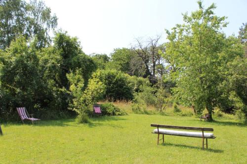 a park bench sitting in the grass in a field at Les vieux fourneaux in Nantiat