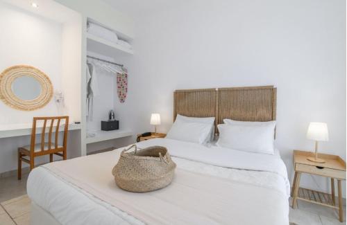 a bedroom with a bed with a basket on it at Koukounari Apartments in Skala