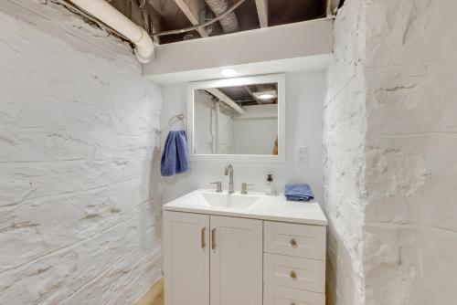 a white bathroom with a sink and a mirror at Pet-Friendly St Louis Home with Grill and Backyard in Richmond Heights