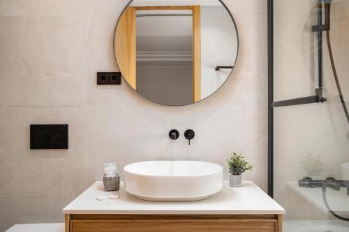 a bathroom with a sink and a mirror at Apartamentos La Zagalilla in Málaga
