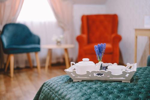 a table with a tea set on top of a bed at Hotel DENINNA in Vinnytsya