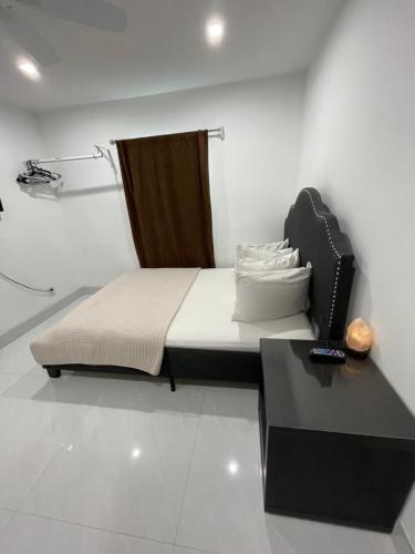 a bedroom with a bed and a black table at Bedroom and Bathroom 4 in Boca Raton