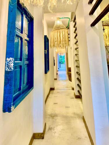 a hallway of a house with a chandelier at Hotel Casa Lucca in Medellín