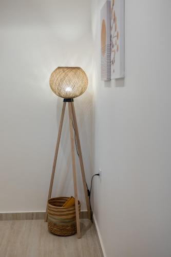 a wooden stool with a basket next to a wall at Nona's House in Skala Kefalonias