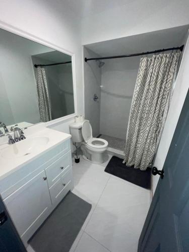 a bathroom with a toilet and a sink and a shower at bedroom with sharing bathroom in Boca Raton