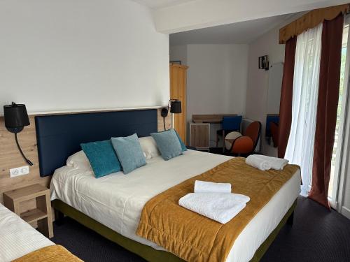 Ένα ή περισσότερα κρεβάτια σε δωμάτιο στο Hôtel Le Blainon