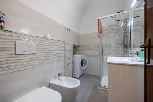 a bathroom with a toilet and a sink and a shower at In the heart of Finalmarina in Finale Ligure