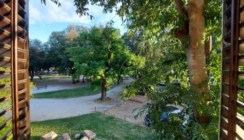 a view of a park from a window at City Center Lodge in Pula