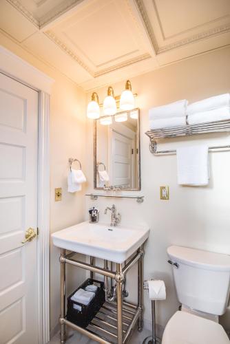 a bathroom with a sink and a toilet and a mirror at The Pollard Hotel in Red Lodge