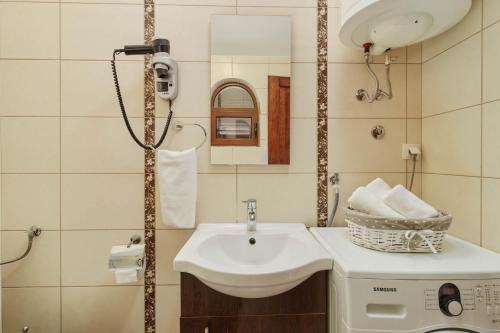 a bathroom with a sink and a washing machine at Apartments Djuranovic in Kotor