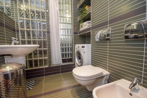 a bathroom with a toilet and a sink at Apartment Old Centre - Panska in Bratislava