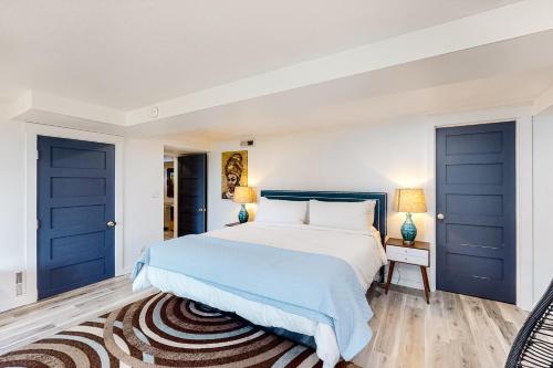 a bedroom with blue doors and a bed with a rug at Ghost Hole View in Bay City
