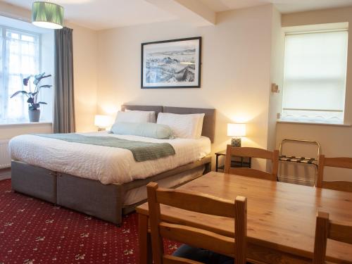 a bedroom with a bed and a table and a dining room at The Ramblers' Rest - Princetown in Princetown