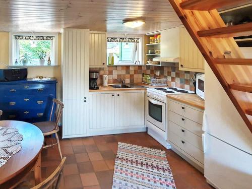 a small kitchen with white cabinets and a table and a table and a tableablish at Holiday home in Ronneby in Ronneby