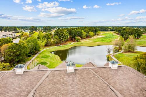 an aerial view of a golf course and a pond at Friends Delight in Calabash