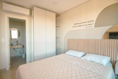 1 dormitorio con 1 cama con sábanas blancas en Monoambiente al alcance de todo en Asunción-Luque, en Luque