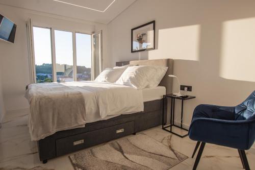 a bedroom with a bed and a chair and a window at villa Ana in Preko