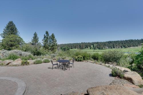 a patio with a table and two chairs on it at Klamath Falls Getaway with Pool and Hot Tub Access! in Klamath Falls