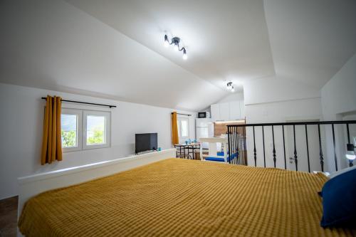 a bedroom with a large bed and a window at Studio apartment Villa Radovic in Strp