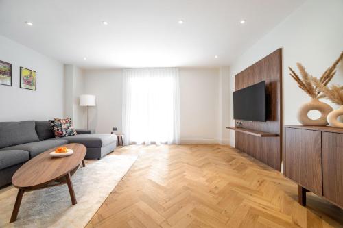 a living room with a couch and a table at The Heart of Westminster in London