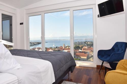 a bedroom with a bed and a large window at villa Ana in Preko
