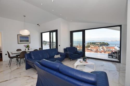 a living room with a blue couch and a table at villa Ana in Preko
