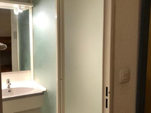a bathroom with a sink and a mirror at Charmant T2 Cabine au pied des pistes avec parking privé à Enchastrayes - FR-1-165A-144 in Enchastrayes