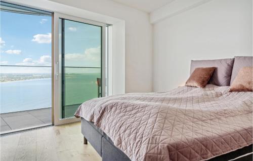 a bedroom with a bed and a view of the ocean at Light House in Aarhus