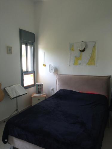 a bedroom with a bed and a window and a keyboard at Квартира с высокими потолками. in Migdal