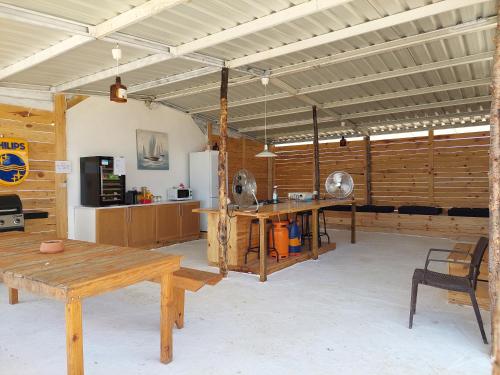 a large room with a table and a refrigerator at COMPORTA SIDE - Tents in Setúbal