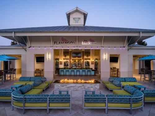 a hotel front with chairs and a fire pit at TownePlace Suites Orlando at FLAMINGO CROSSINGS® Town Center/Western Entrance in Orlando
