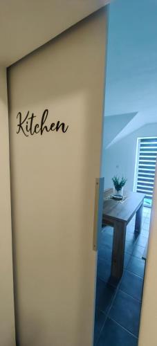 a sign that says kitchen on the side of a building at Rooms Osmica- Videm pri Ptuju in Videm pri Ptuju
