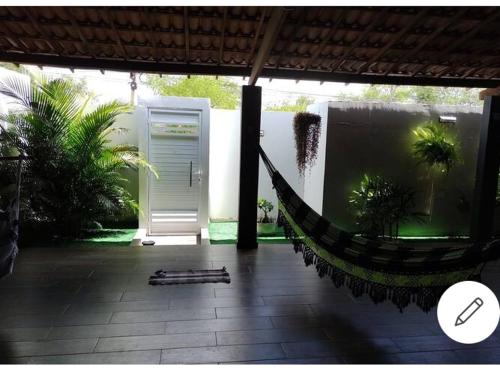 a hammock in the middle of a patio at casa de temporada em Piranhas ótimo lugar e conforto lila in Piranhas