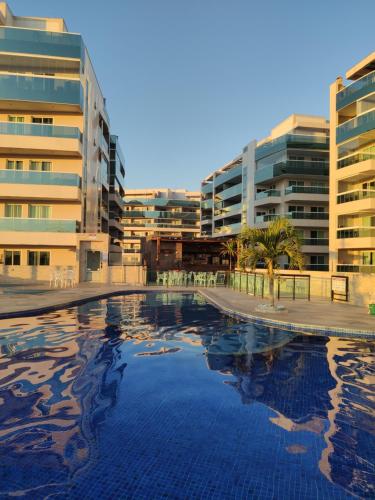 a large swimming pool in front of some buildings at Le Bon Vivant, Nosso Lar in Arraial do Cabo