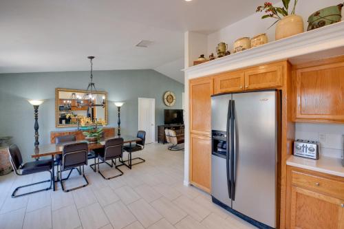 a kitchen with a stainless steel refrigerator and a table at Updated Abode 22 Mi to Joshua Tree National Park! in Morongo Valley