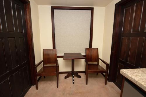 a dining room with a table and two chairs at PUR Boutique Cabanas, Adults Only in San Pedro