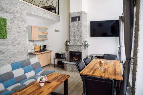 a living room with a table and a fireplace at Oxigen Dream in Râşnov