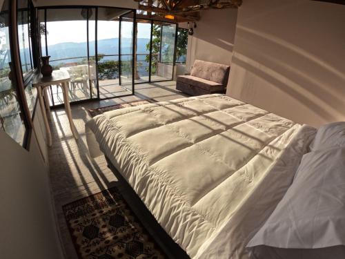 a large bed in a room with a window at Eco Lodge SOL- SUE in La Mesa