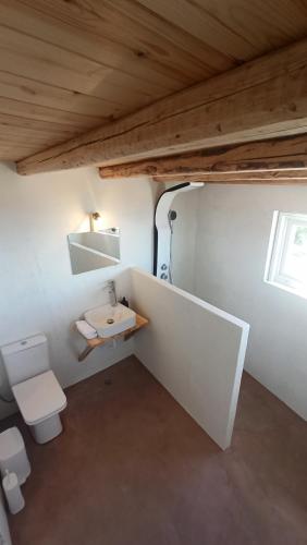 a small bathroom with a sink and a toilet at Sun Meets Sea in Athanion