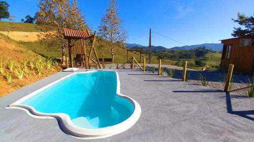 a swimming pool in a driveway with a gazebo at CABANA PARAÍSO in Santo Amaro da Imperatriz