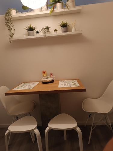 a table and two stools in a room at Apartman Vervis Varaždin in Varaždin