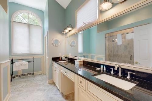 a bathroom with two sinks and a large mirror at Salt Pond --- 314 Walkabout Rd in Bethany Beach