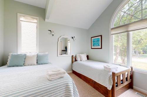 two beds in a room with a window at Salt Pond --- 314 Walkabout Rd in Bethany Beach
