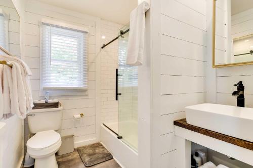 a white bathroom with a toilet and a sink at Folcroft Vacation Rental about 10 Mi to Philadelphia! 
